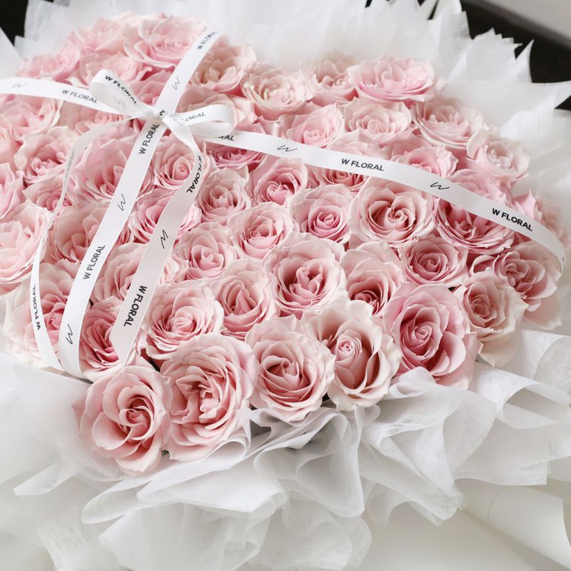 Romantic pink rose bouquet arranged in a classic heart shape