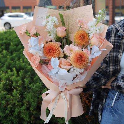 Peach and blush hand-tied flower bouquet with seasonal blooms