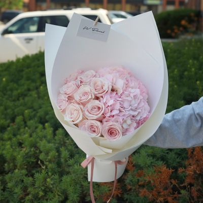Blush pink hydrangea and rose bouquet with modern wrapping