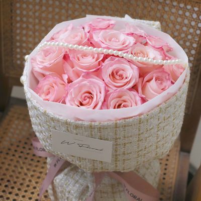 Pink Rhoslyn rose bouquet with tweed wrapping and pearl details