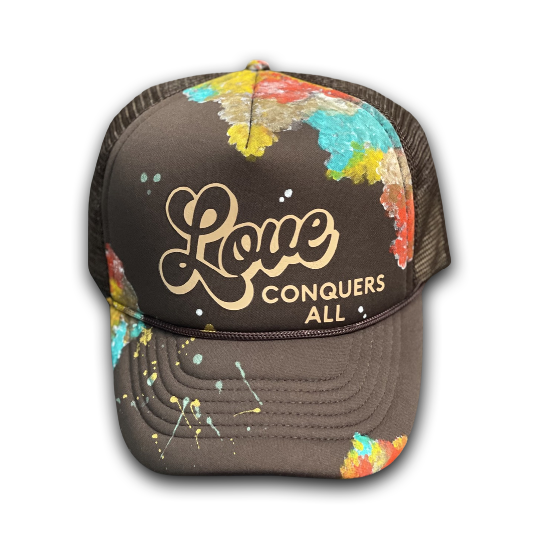 Brown “Love Conquers All” Trucker Hat