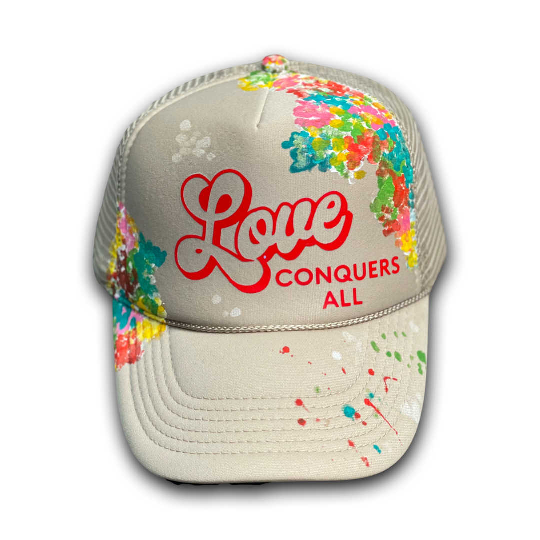 Tan “Love Conquers All” Trucker Hat