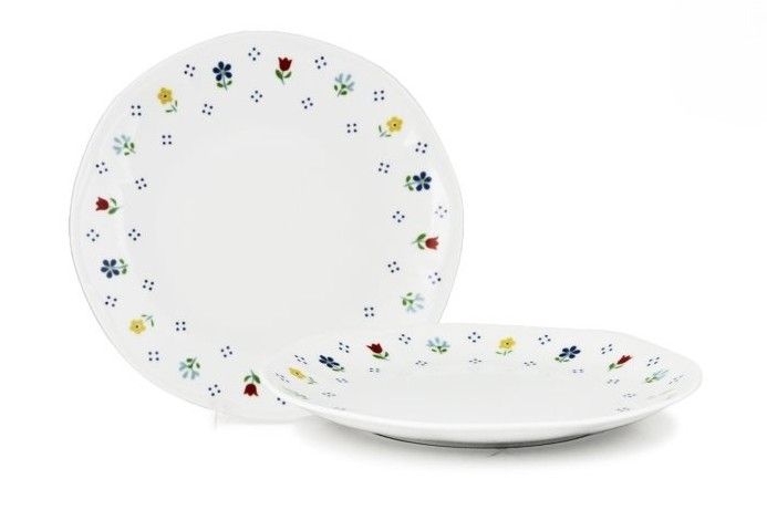 24 cm Jastra white porcelain flat plate with floral wavy rim for horeca use