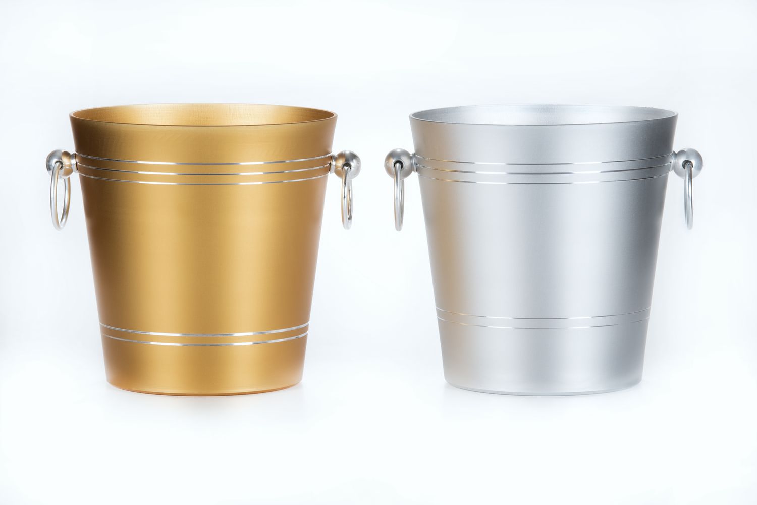 Tirolix ice bucket made of gold anodized aluminum with chrome knobs.