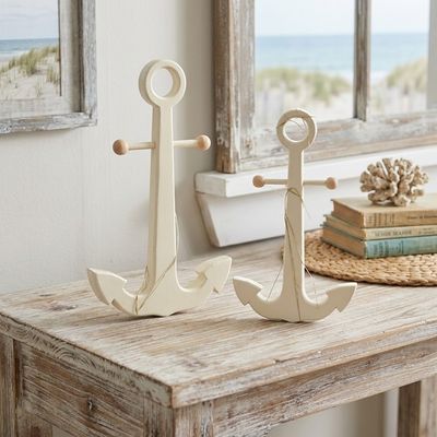 nautical anchors made out of wood sitting on a cottage desk