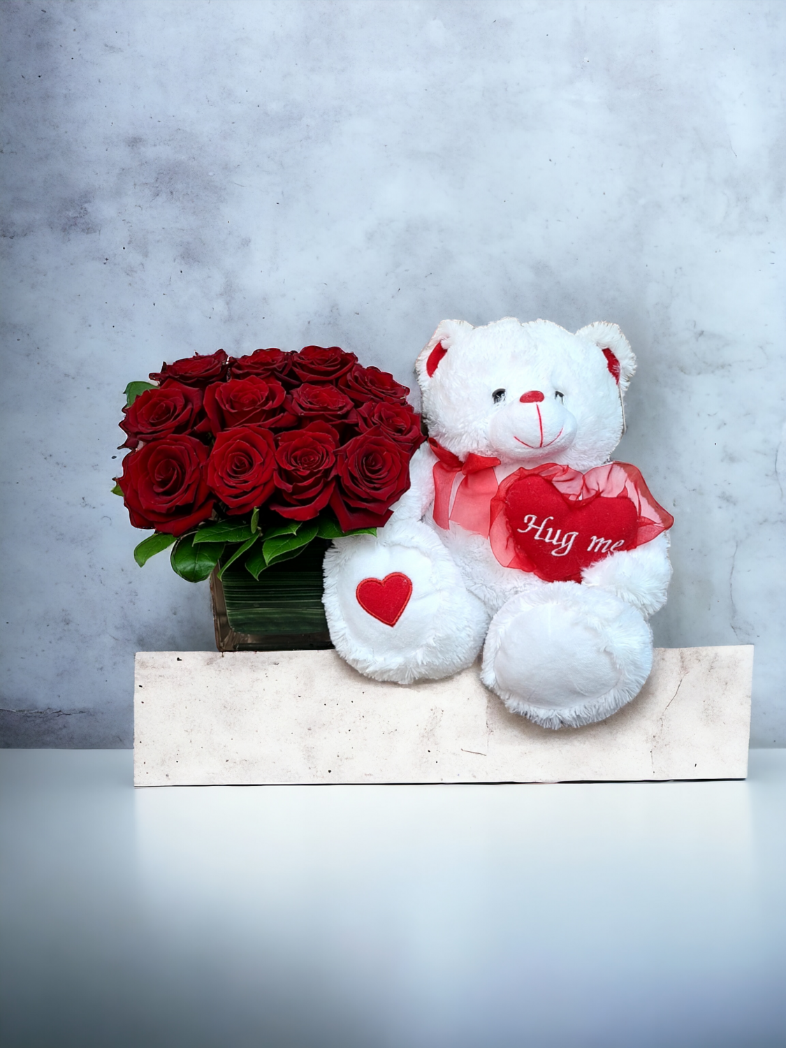 Dozen roses with adorable teddy bear.