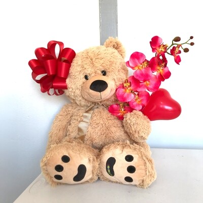 Big teddy bear with bow and orchid