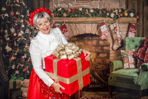 Mrs. Claus brings a gift from Santa