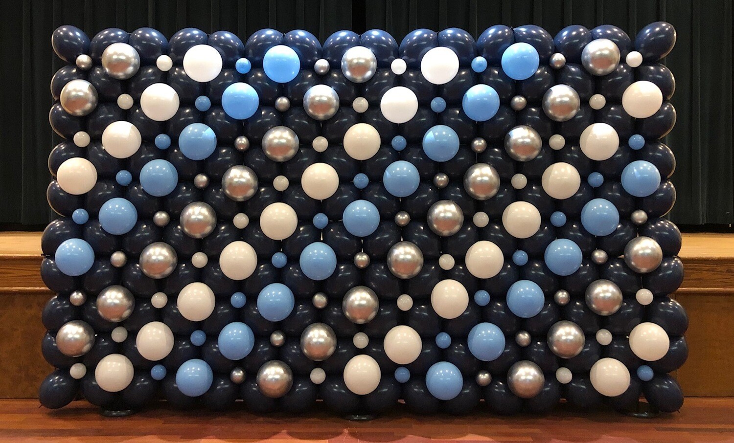 Balloon wall backdrop, indoors, traditional single layer (even sized bubbles) Balloon wall backdrop, indoors, traditional single layer (even sized bubbles)