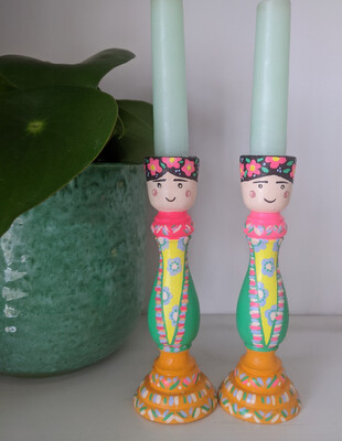 A pair of hand painted Frida inspired candle stick holders