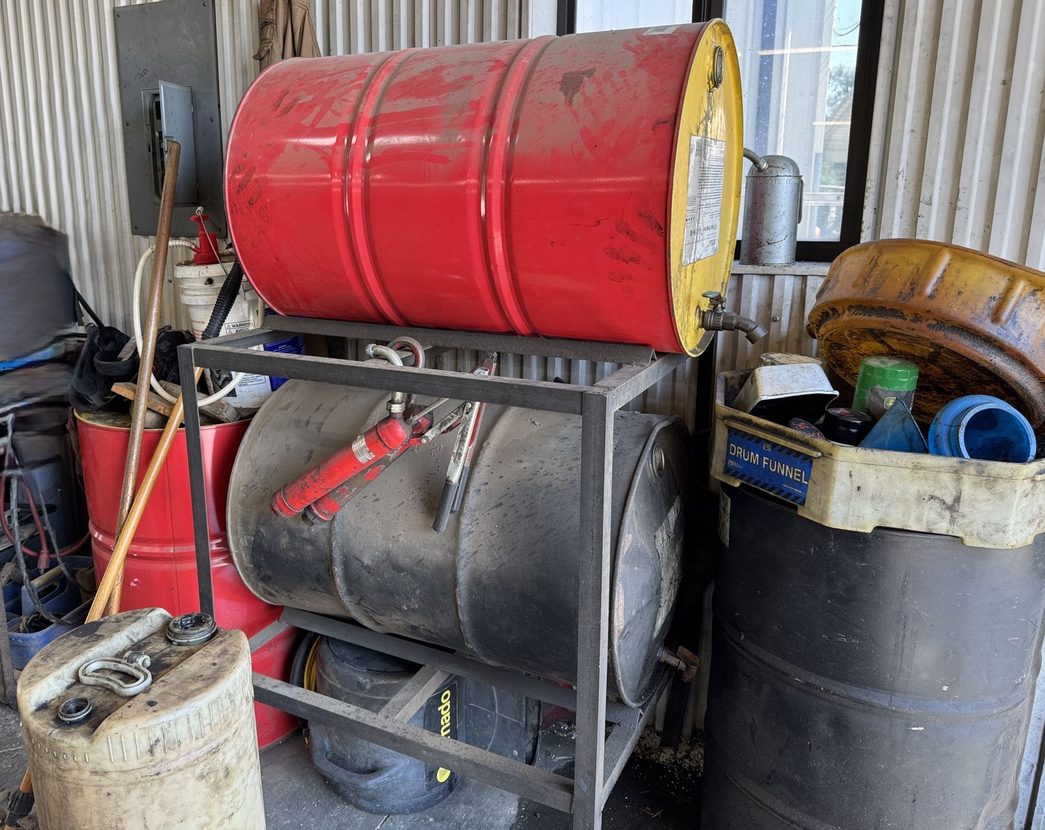 2 OIL DRUMS ON RACKS