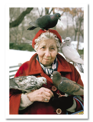 Birds perched on woman in park