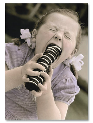 Little girl eating Oreo cookies