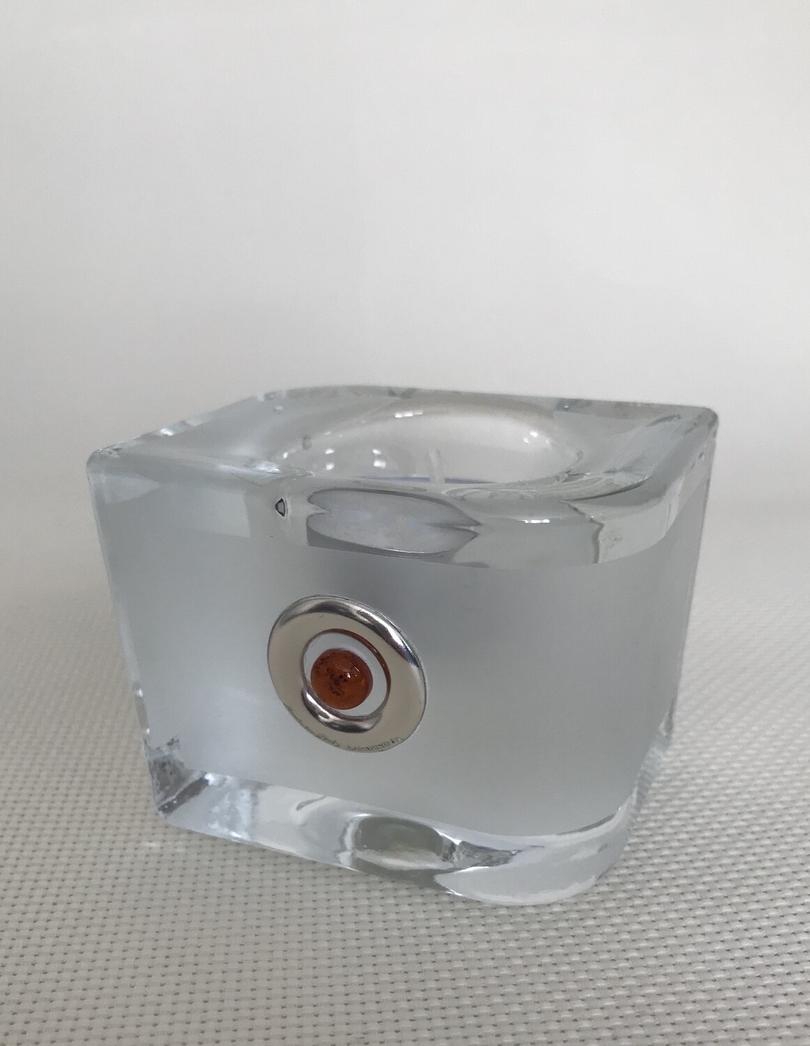 Frosted Glass Candle Holder with Silver and Amber circular motifs.  Irregular shape. Height 6 cm.