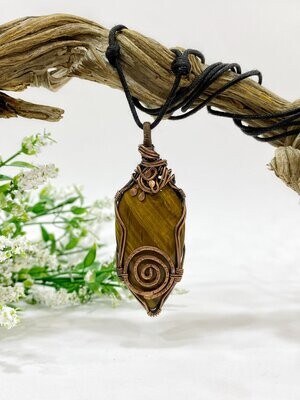 Tiger eye wire wrapped copper pendant with a spiral at the base.