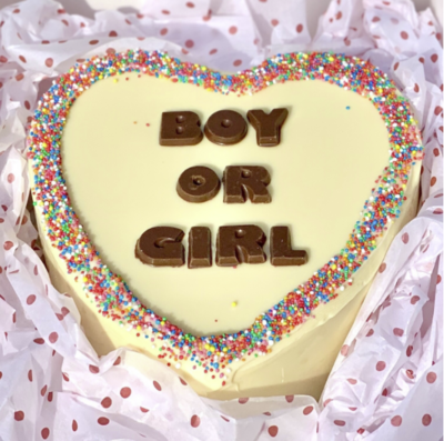 Gender reveal chocolate smash cakes filled with pink or blue lollies for baby announcements.