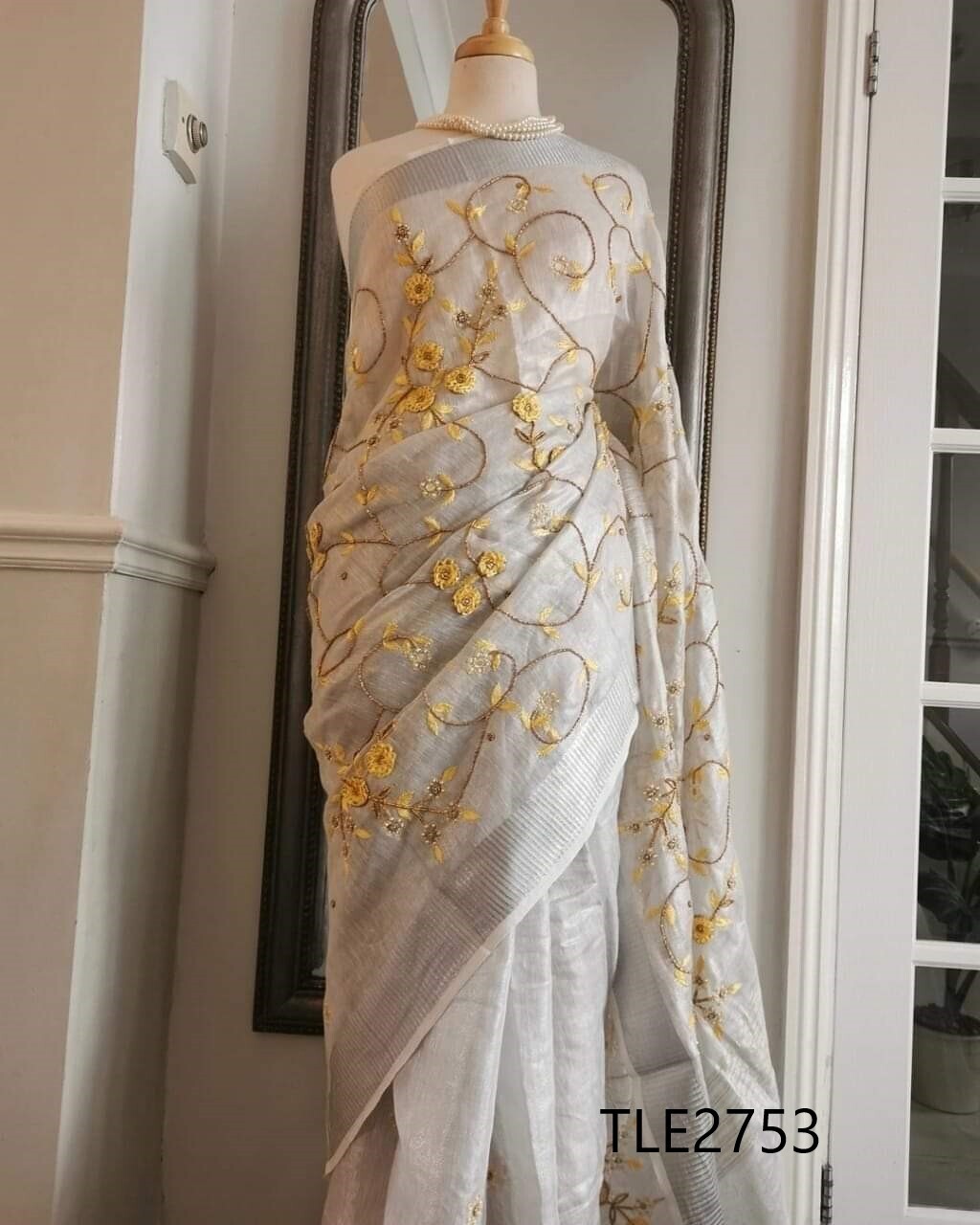 Tissue linen Zari border saree with exclusive new French knot hand motifs work