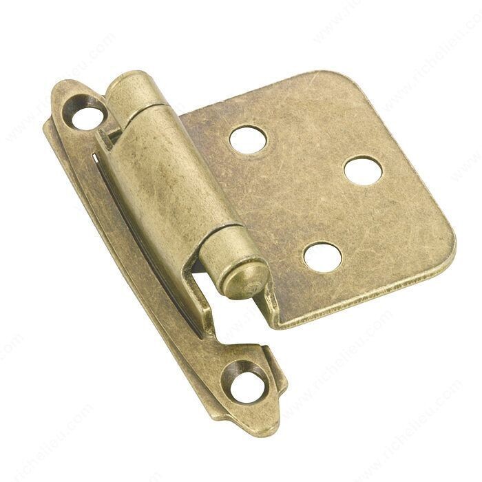 2-3/4 inch self-closing semi-concealed cabinet hinge in an antique brass finish.