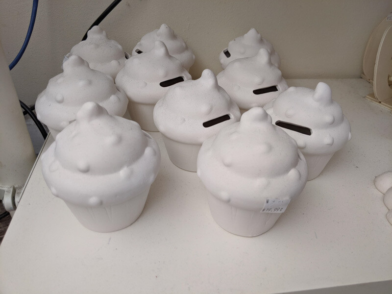 Cupcake figurine piggy bank to paint for with paint and brushes