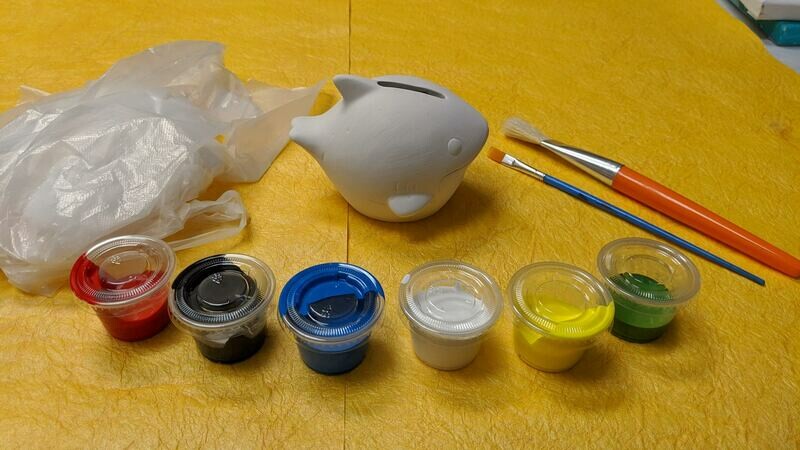 Various Plaster Figurines to paint for kids' Art Craft Activity or Birthday activities with brushes, paints, and apron.