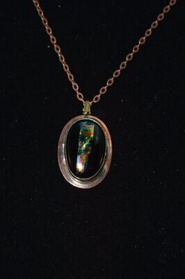 Black glaa pendant set into copper