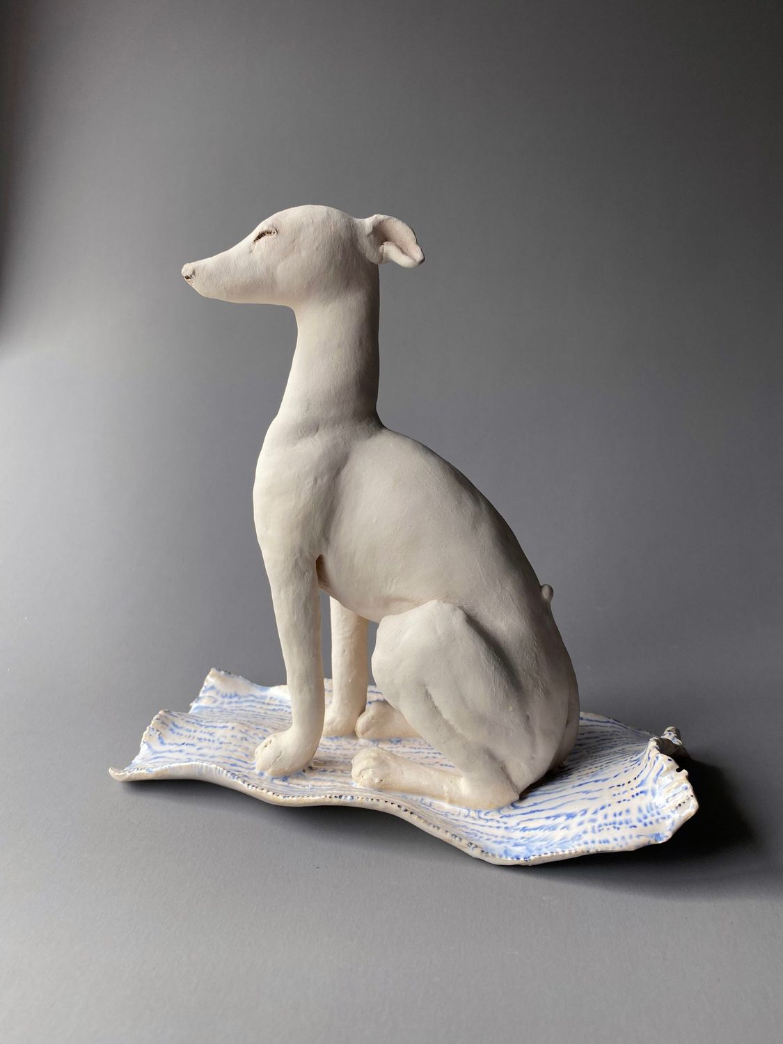 sitting up hound on glazed mat