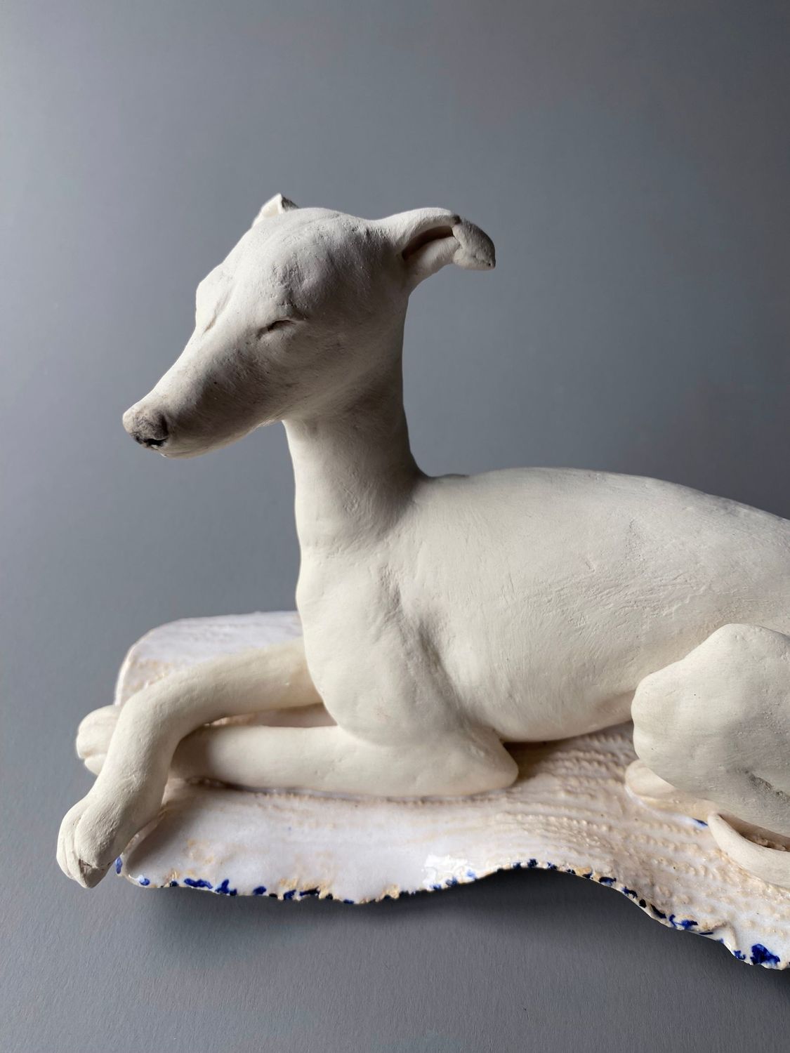 laying hound on glazed mat