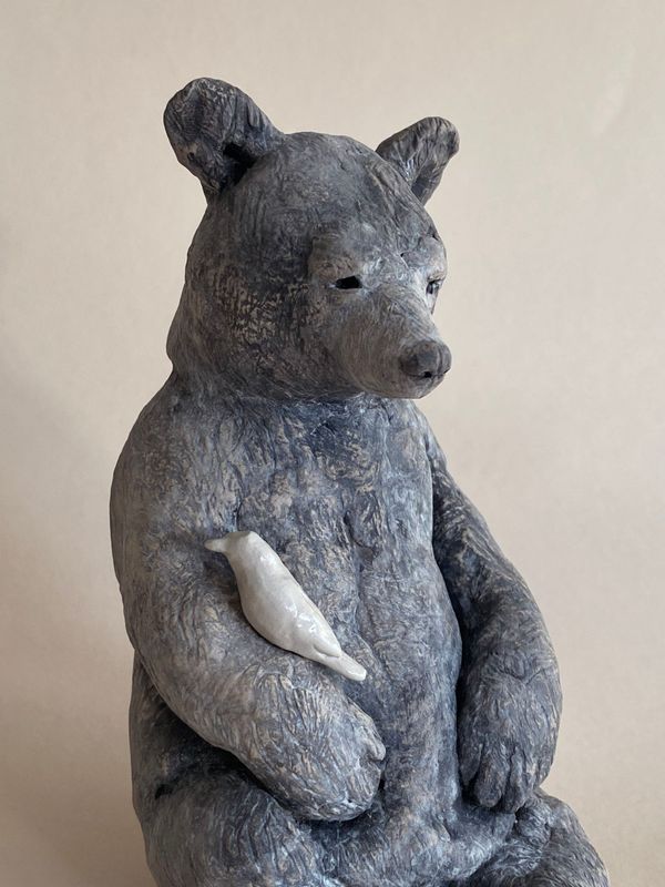 black bear with shiny bird