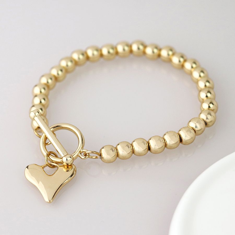 Pom Golden bead and heart charm t-bar bracelet