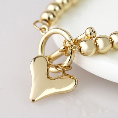 Pom Golden bead and heart charm t-bar bracelet
