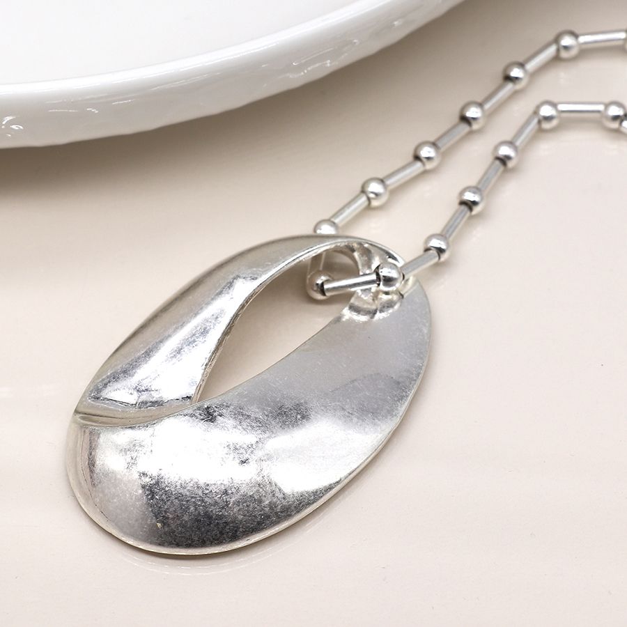 Pom Silver plated station and worn oval necklace