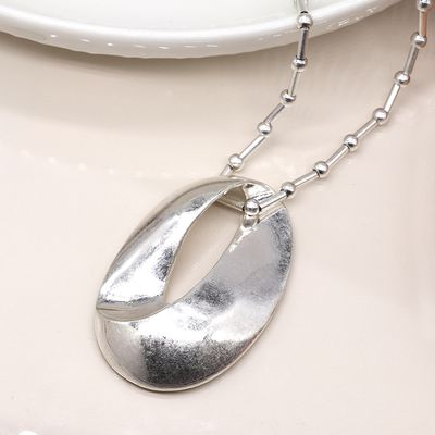 Pom Silver plated station and worn oval necklace