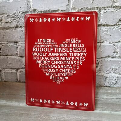 Red Metal Sign With White Heart Filled With Christmas Phrases