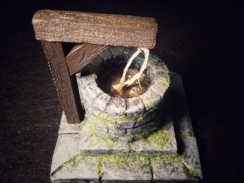 Pozo de piedra con agua y soporte de madera