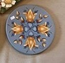 Round blue wall plaque with yellow flowers