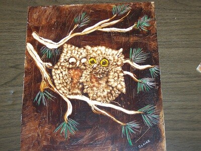 Two owls sitting on a branch, painted on peg board