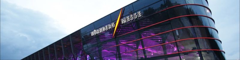 NürnbergMesse logo and branding on a glass facade of the Messe complex