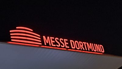 Messe Dortmund branding in red neon light at night