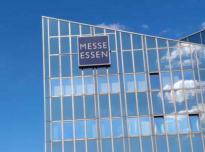 Facade of Messe Essen building with logo against a blue sky