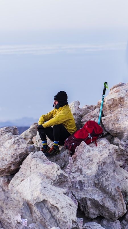 Man resting in the mountains during a hike