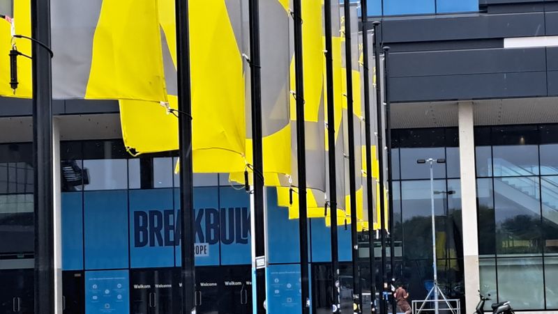Flags in front of main entrance of Rotterdam Ahoy event center during Brekabulk Europe exhibition in 2024