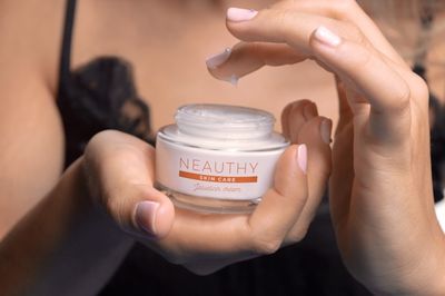 Woman applying skin care cream