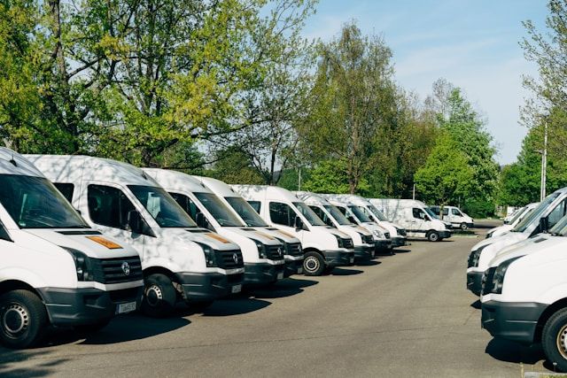 large amount of commercial vehicles/minivans parked