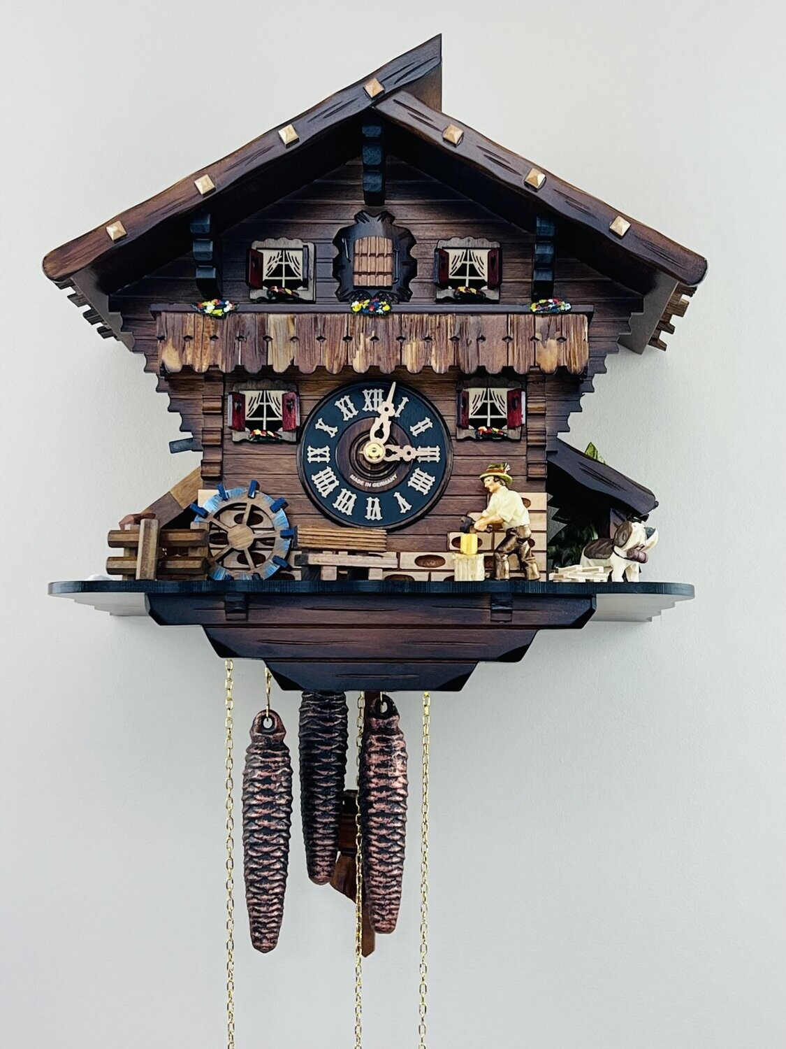 12" One Day Musical Cuckoo Clock Cottage with Man Chopping Wood and Waterwheel