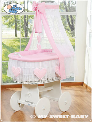 white swinging crib with drapes