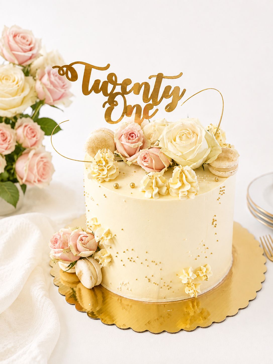 Gold floral birthday cake with fresh flowers, macarons and personalised topper