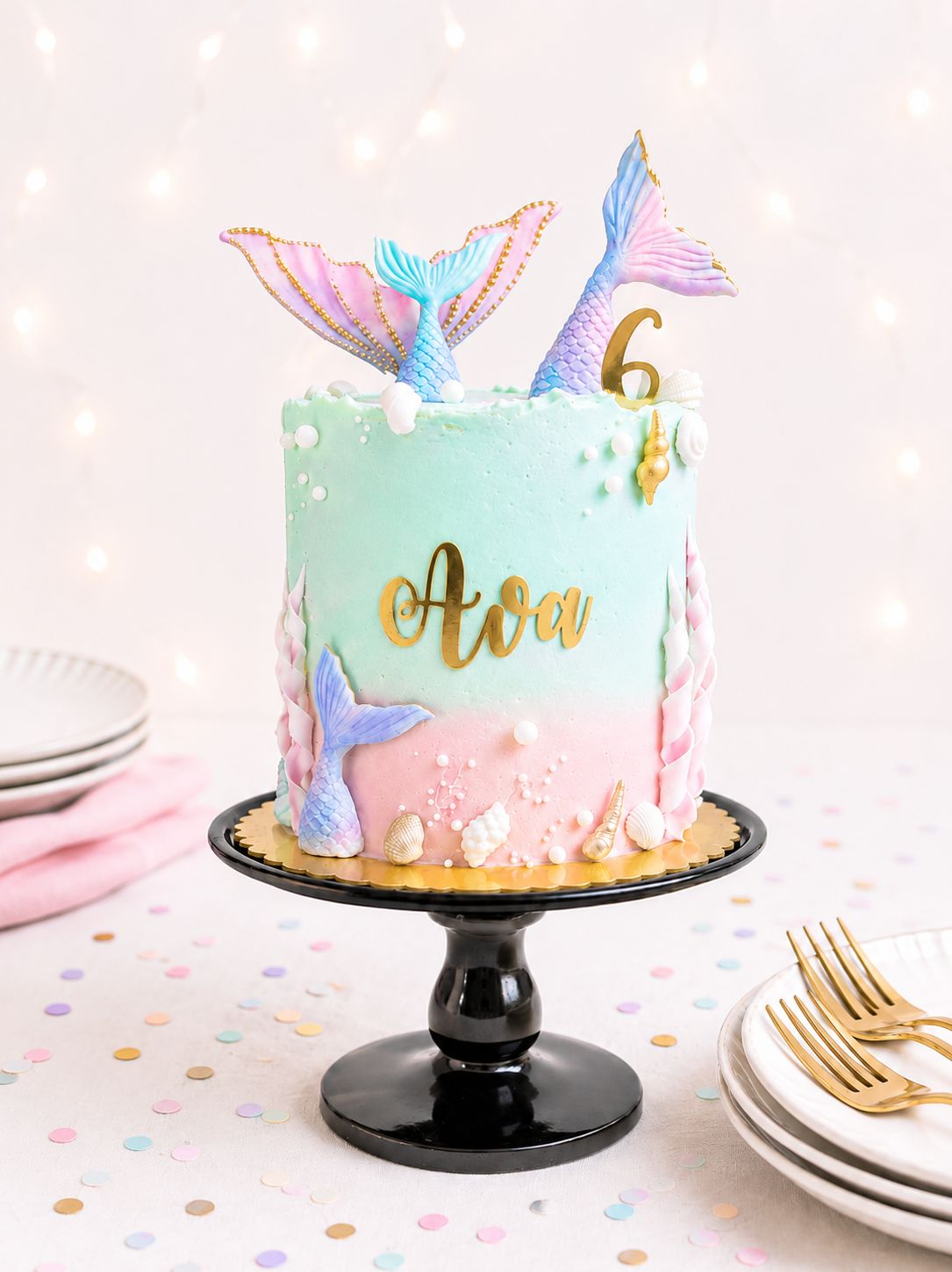 Mermaid birthday cake with handmade sugar mermaid tails, shells and ocean decorations