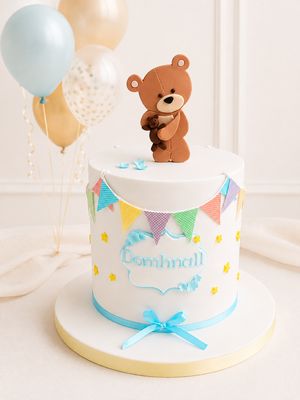 Teddy and bunting celebration cake with handmade sugarcraft decorations