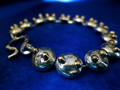 Armlänk silver och guld.