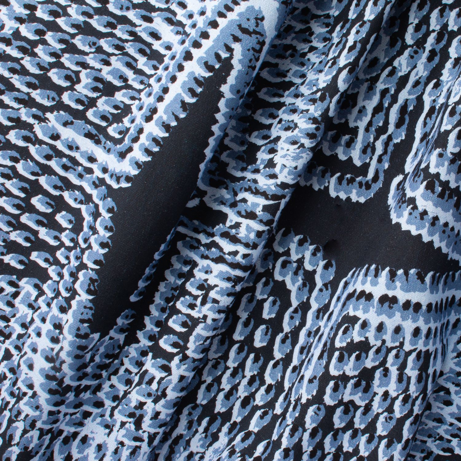 Pilot River fabric displaying scaled-up flame-like marks in blue on cotton-linen